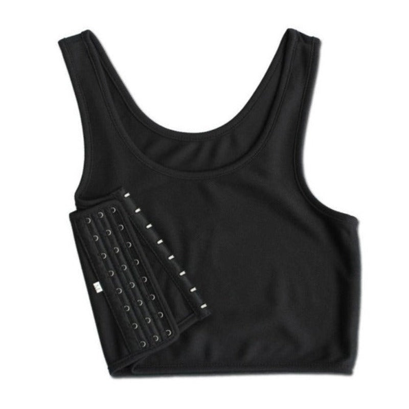 A person is wearing a black breathable chest binder with side buckles, in a standing position.