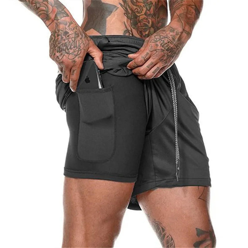 Person wearing black athletic shorts with visible tattoos on arms and legs.