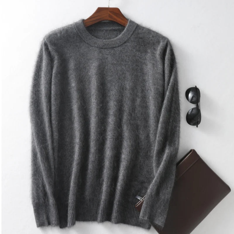 Gray sweater on a hanger with sunglasses and a brown leather case on a white background