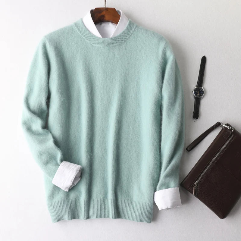 Light green sweater with white cuffs and collar, watch, and wallet on a light gray background