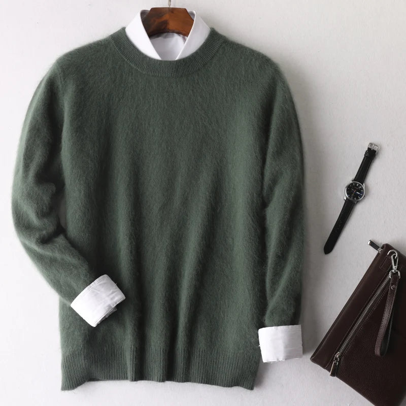 Green sweater with white cuffs and collar on a hanger, next to a watch and brown bag on a white background