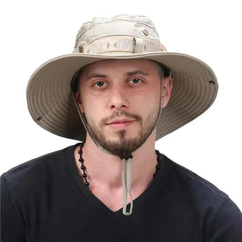 Man wearing a wide-brimmed beige hat on a white background