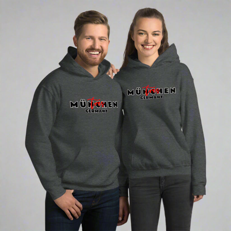 Two people wearing dark gray hoodies with 'München Germany' text on a plain background
