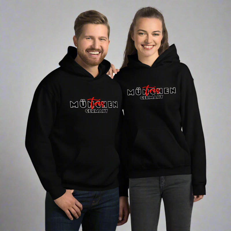 Two people wearing black hoodies with a logo and text on a gray background