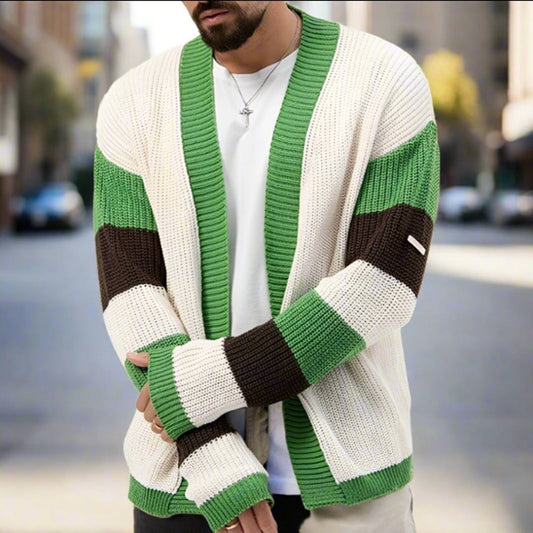 Person wearing a green and white striped cardigan on a blurred street background