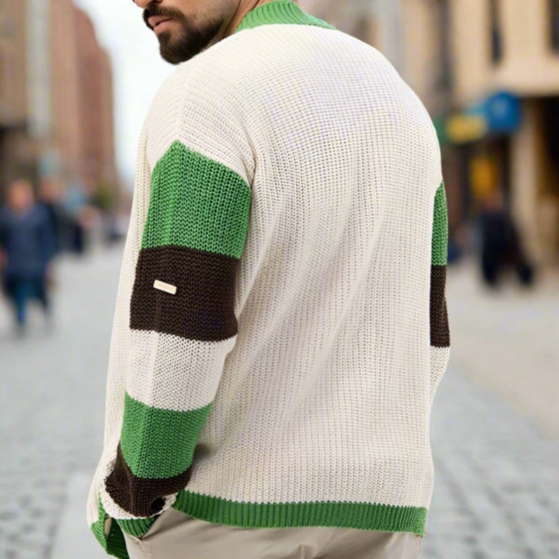 Person wearing a white sweater with green and black stripes in an urban setting