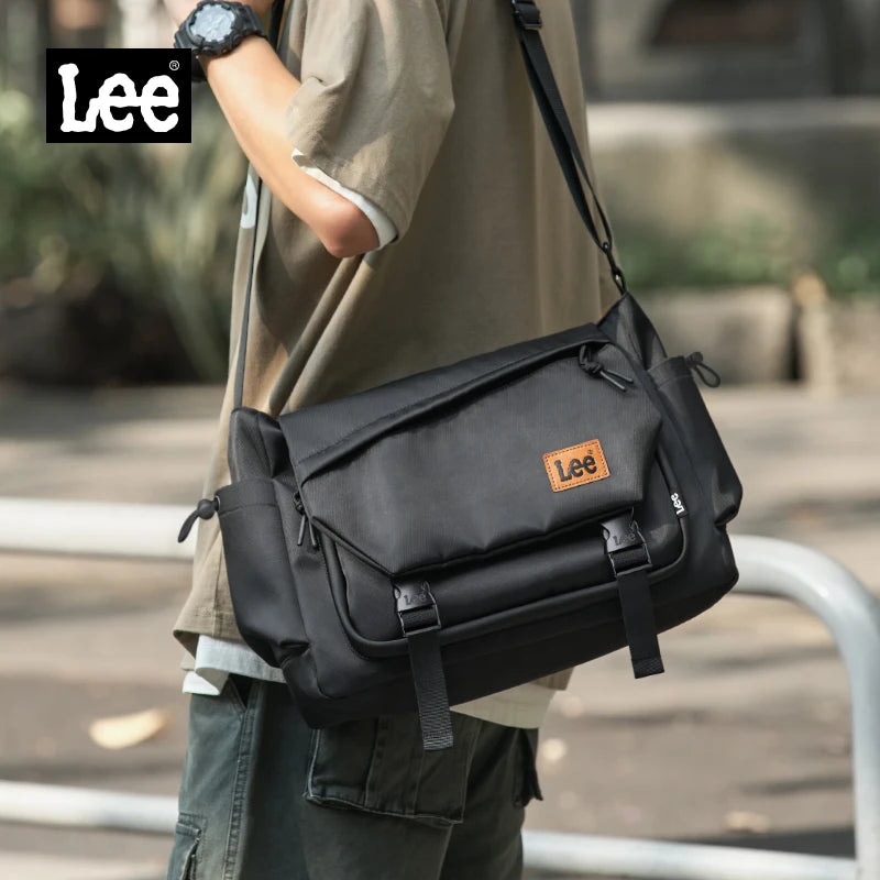 Person carrying a black Lee bag outdoors with the brand logo visible.