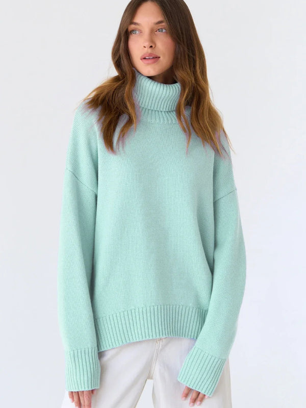 Woman wearing a light blue sweater with a plain background