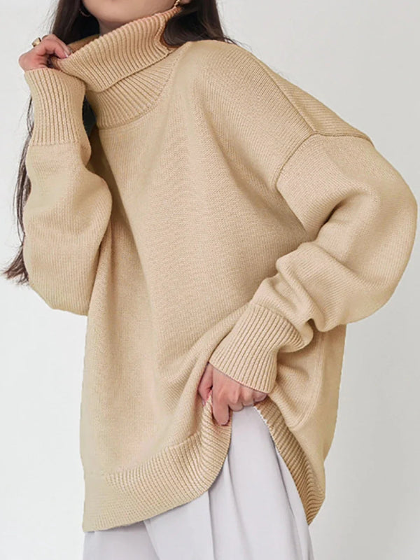 Person wearing a beige sweater with a plain background