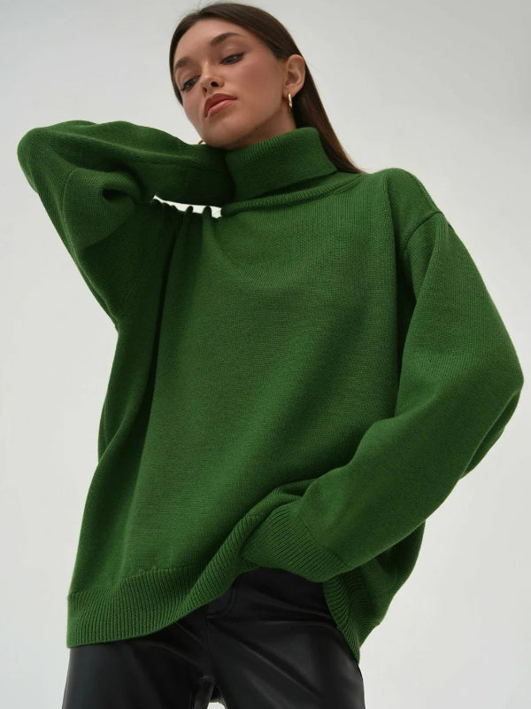 Person wearing a green sweater with a plain background