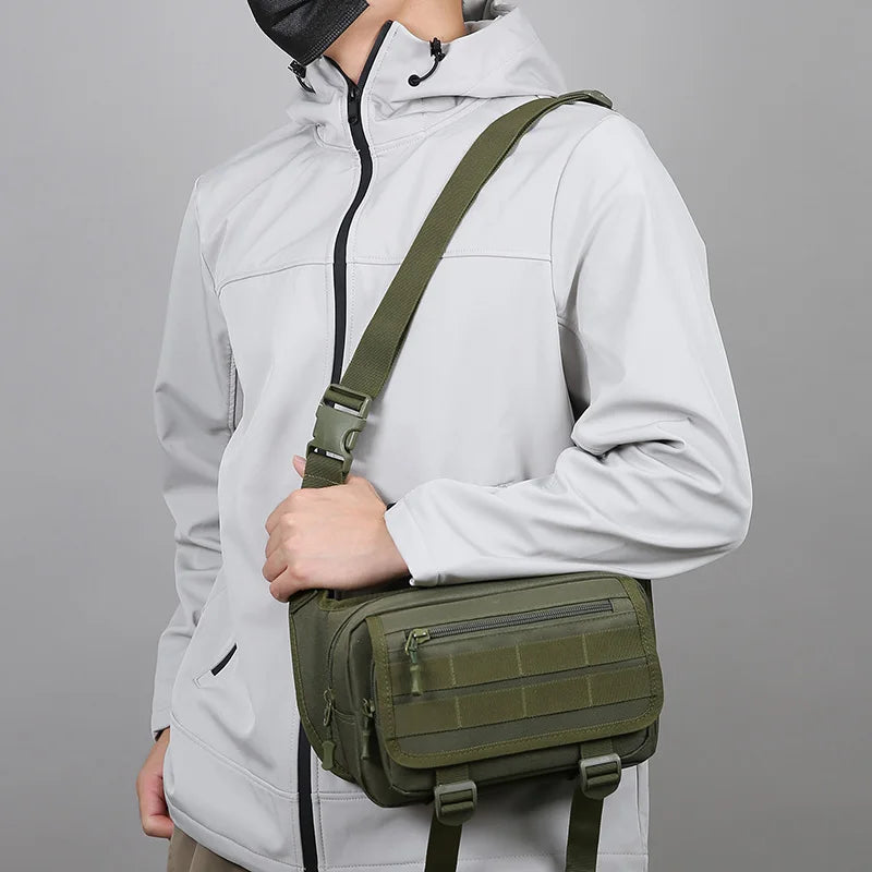 Person wearing a light gray jacket with a green crossbody bag on a gray background