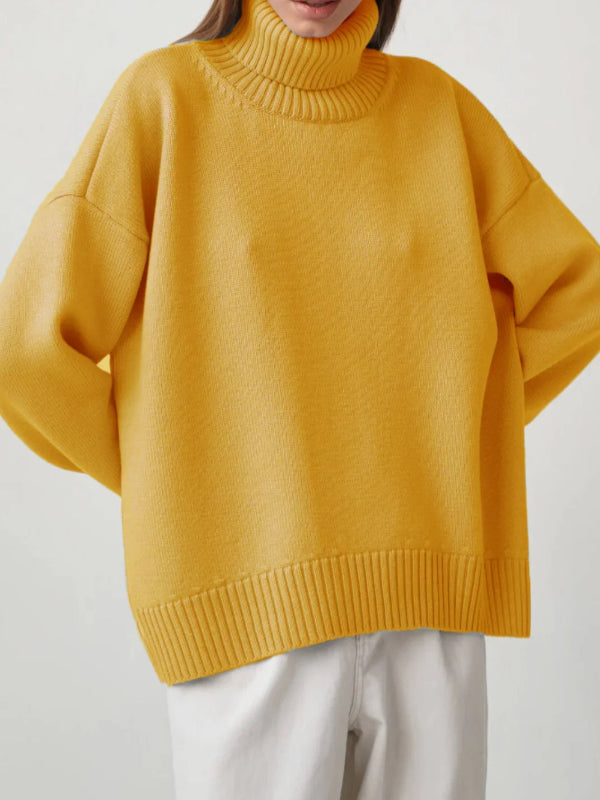 Person wearing a mustard yellow sweater with a plain background, branded 'Bornladies'.