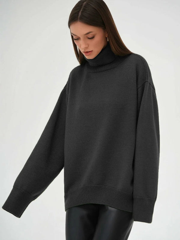 Woman wearing a black oversized sweater on a white background with 'Bornladies' branding.