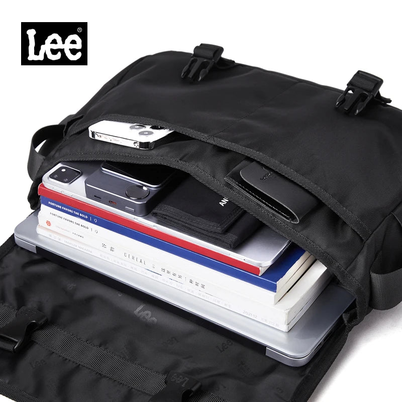 Black backpack with phone, books, and wallet on a white background