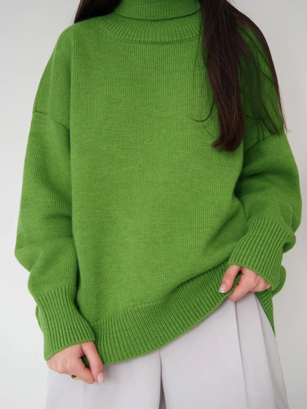 Person wearing a green sweater with a plain background