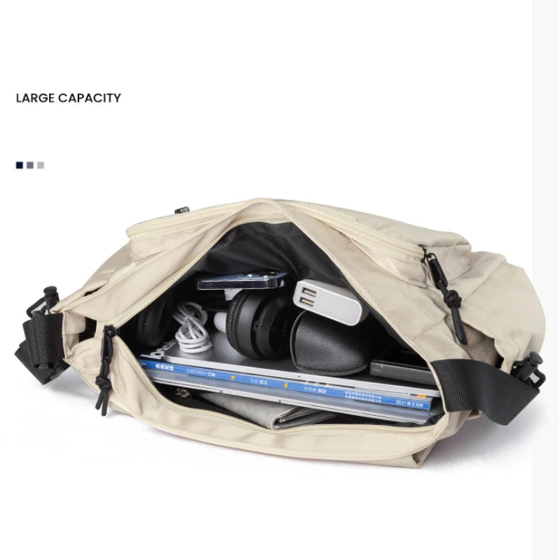 Beige crossbody bag with large capacity, showing interior with electronic devices on a white background.