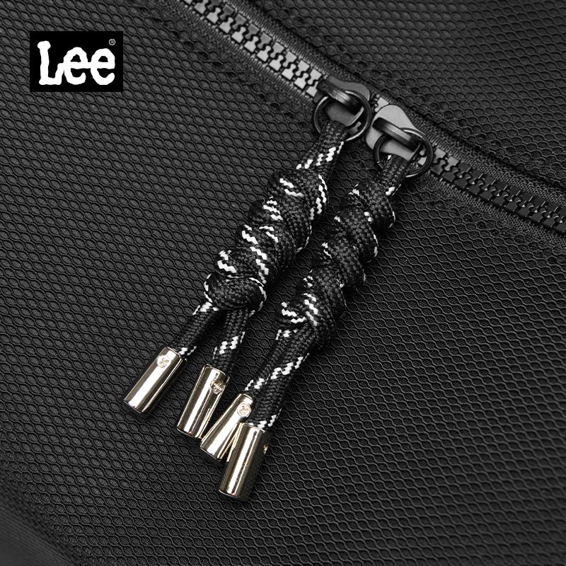 Black shoelaces with silver tips on a textured black surface, featuring the Lee brand logo.