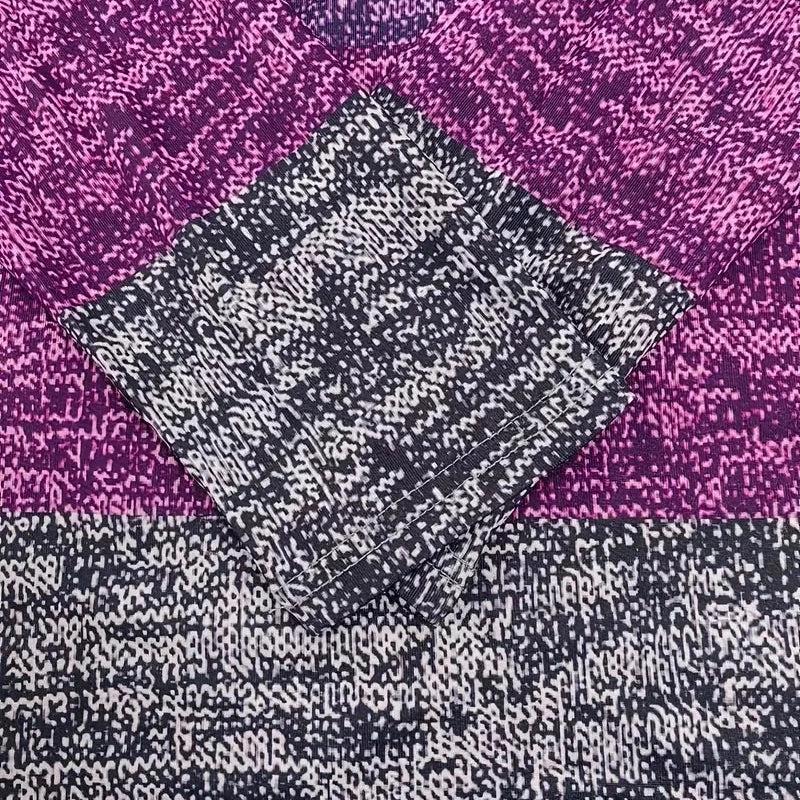 Close-up of a textured fabric with a diamond pattern on a purple background