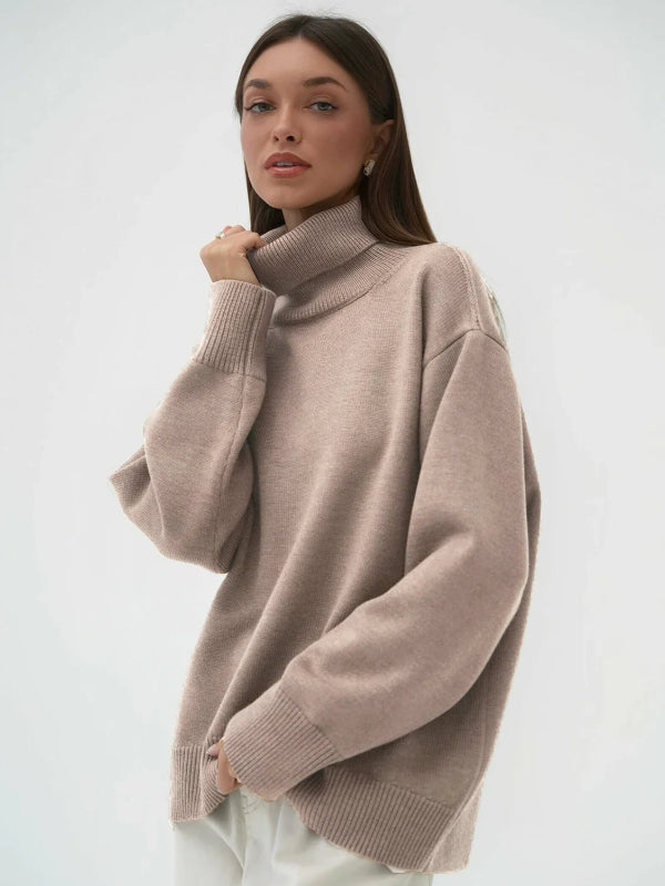 Woman wearing a beige sweater against a white background