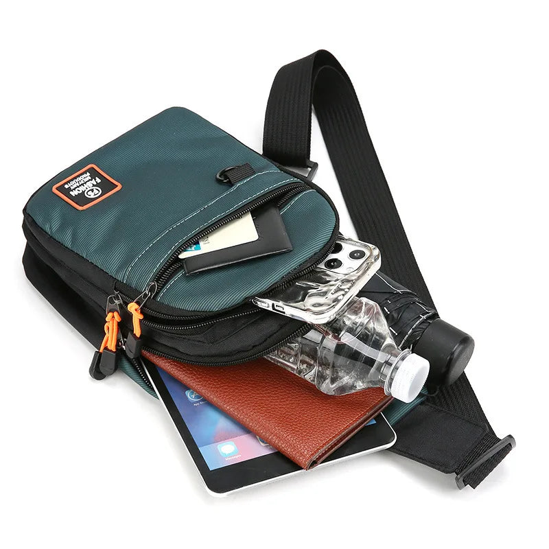 Green crossbody bag with phone, water bottle, and tablet on a white background
