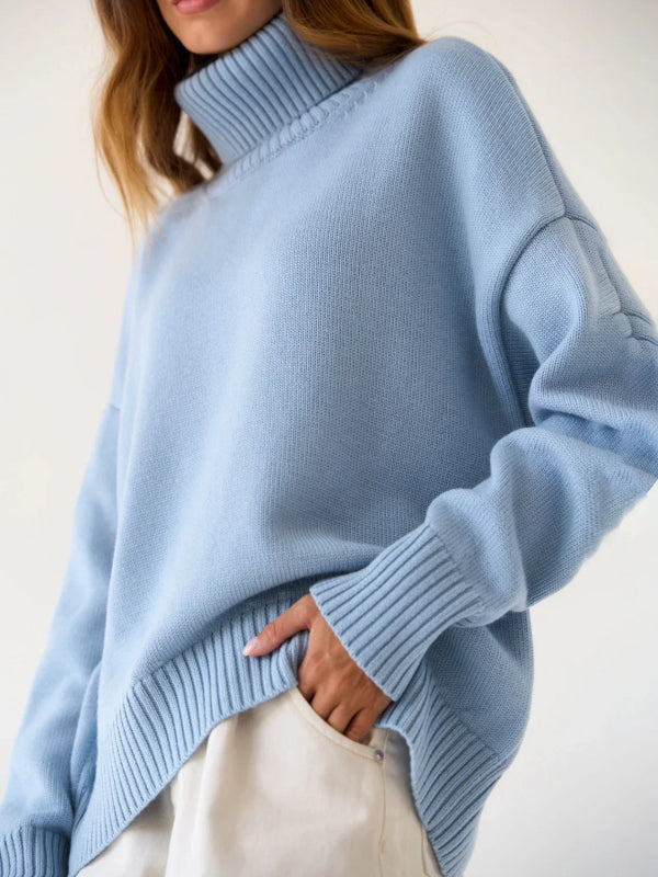 Woman wearing a light blue sweater with a plain background