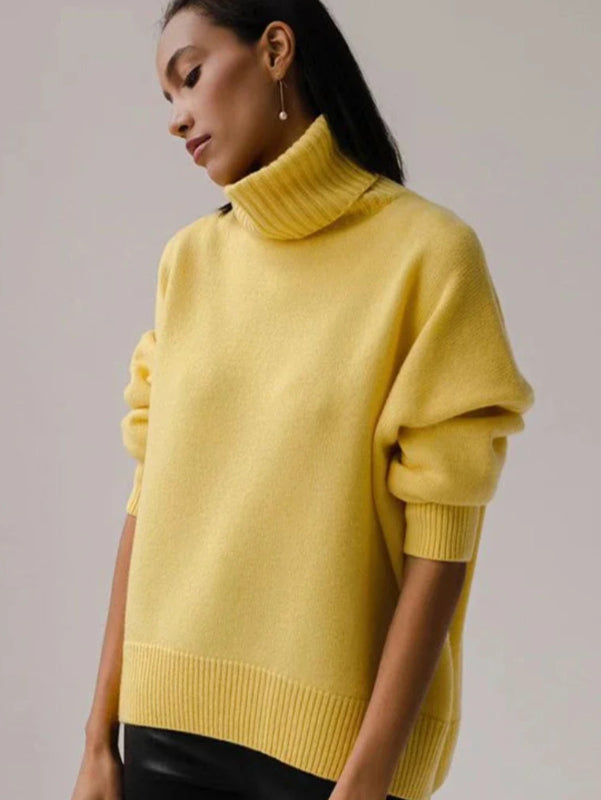 Woman wearing a yellow sweater with a plain background